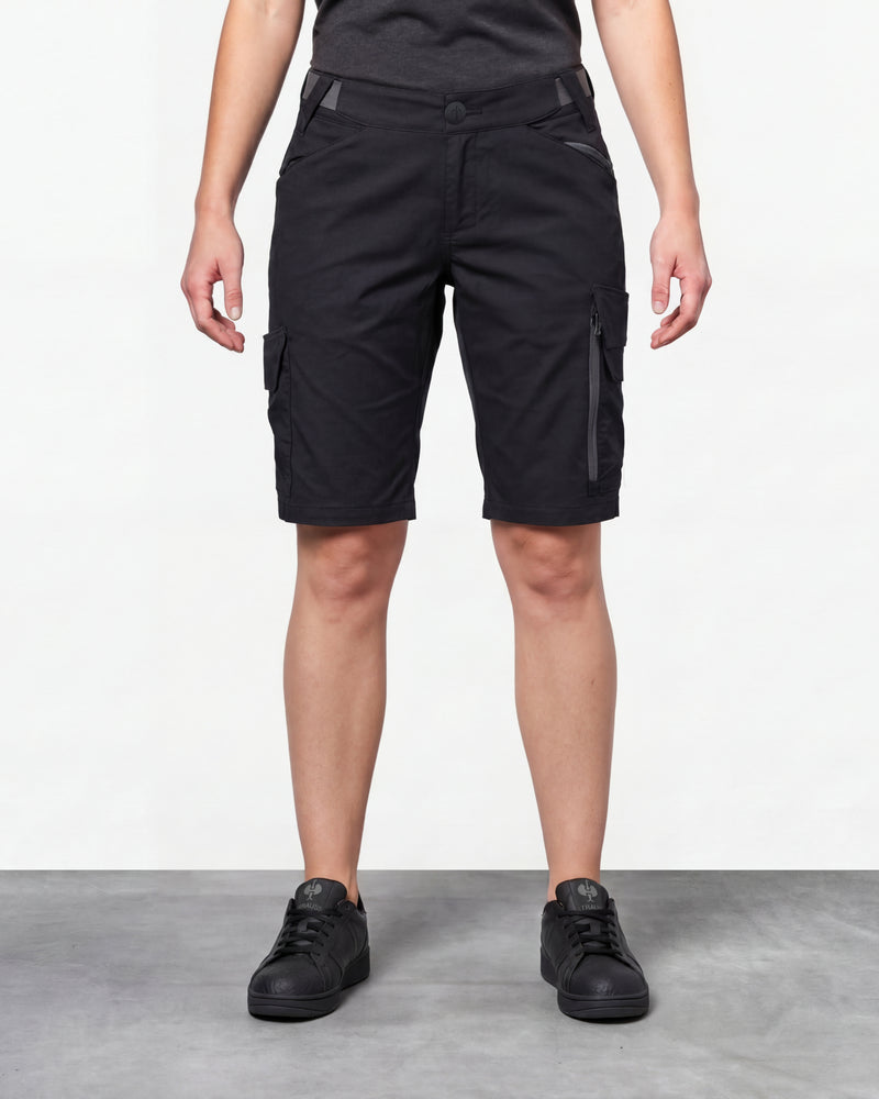 Model wearing Engelbert Strauss women's e.s. trail pure cargo work shorts in black and carbon gray, showing the fit, length, waistband, and front pocket layout of the two-tone women’s cargo work shorts with reinforced utility styling.