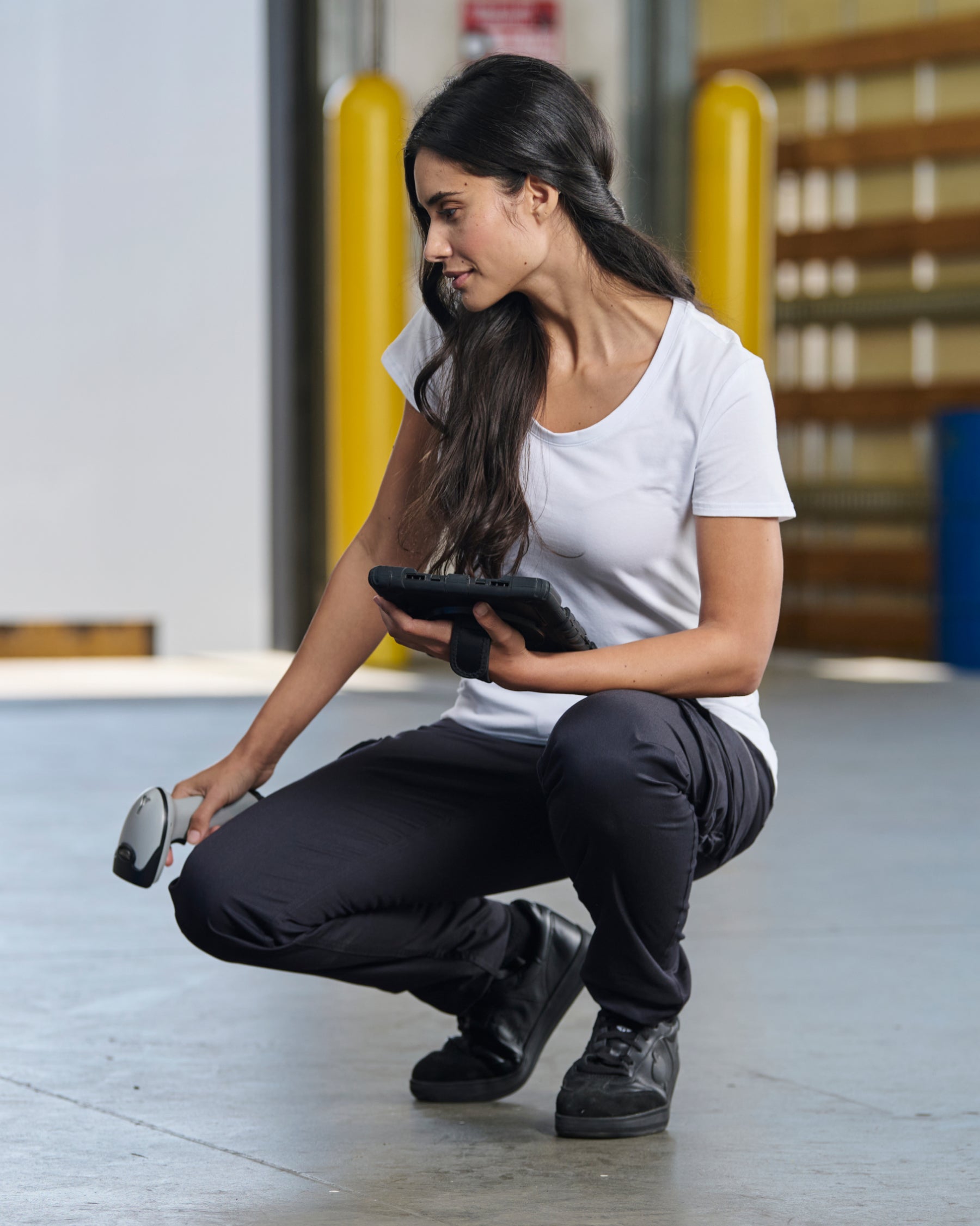 Women's Cargo Work Pants e.s.trail pure in black/carbon gray in use, showing fit and movement