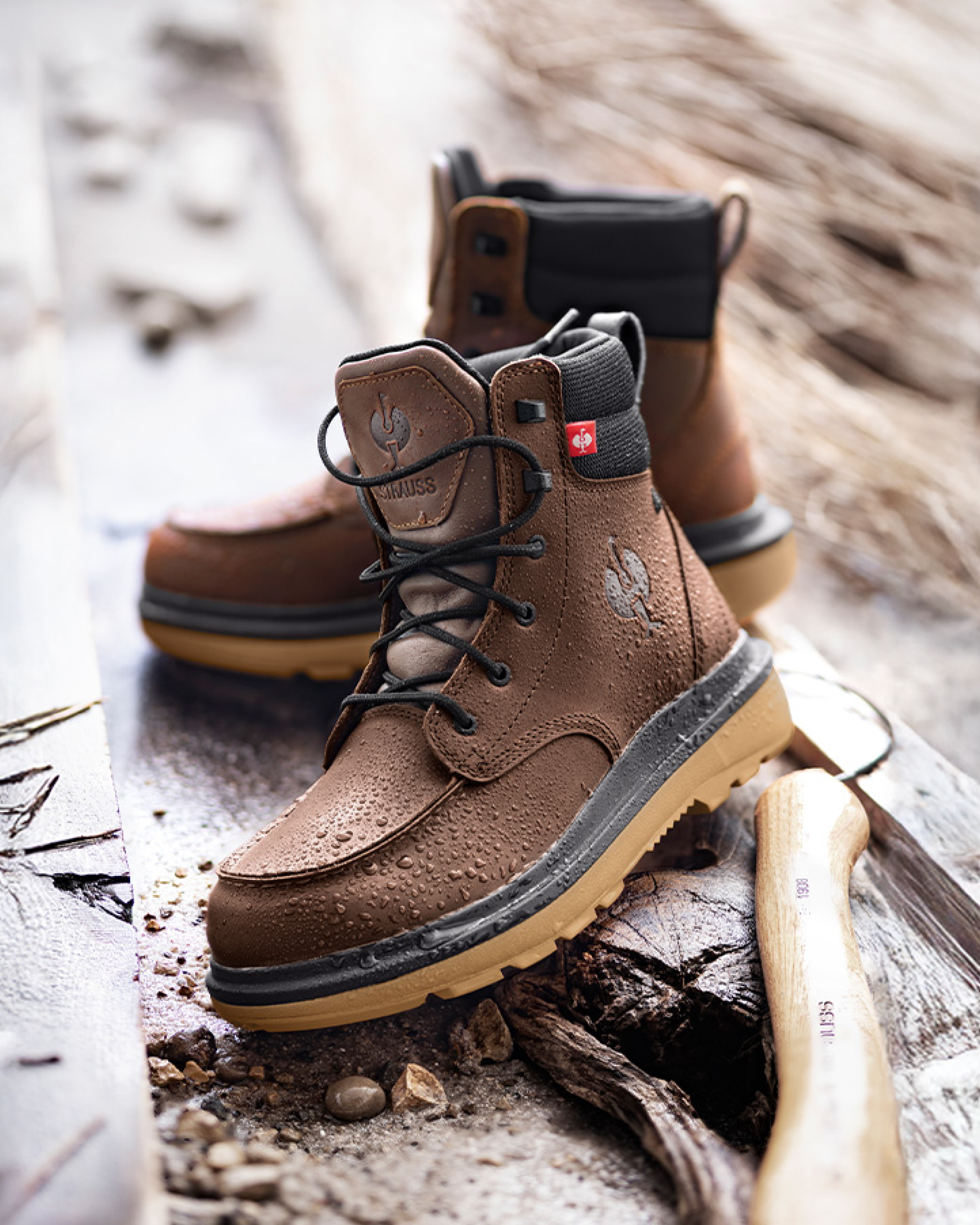 Brown work boots with visible brand logo on a wooden surface