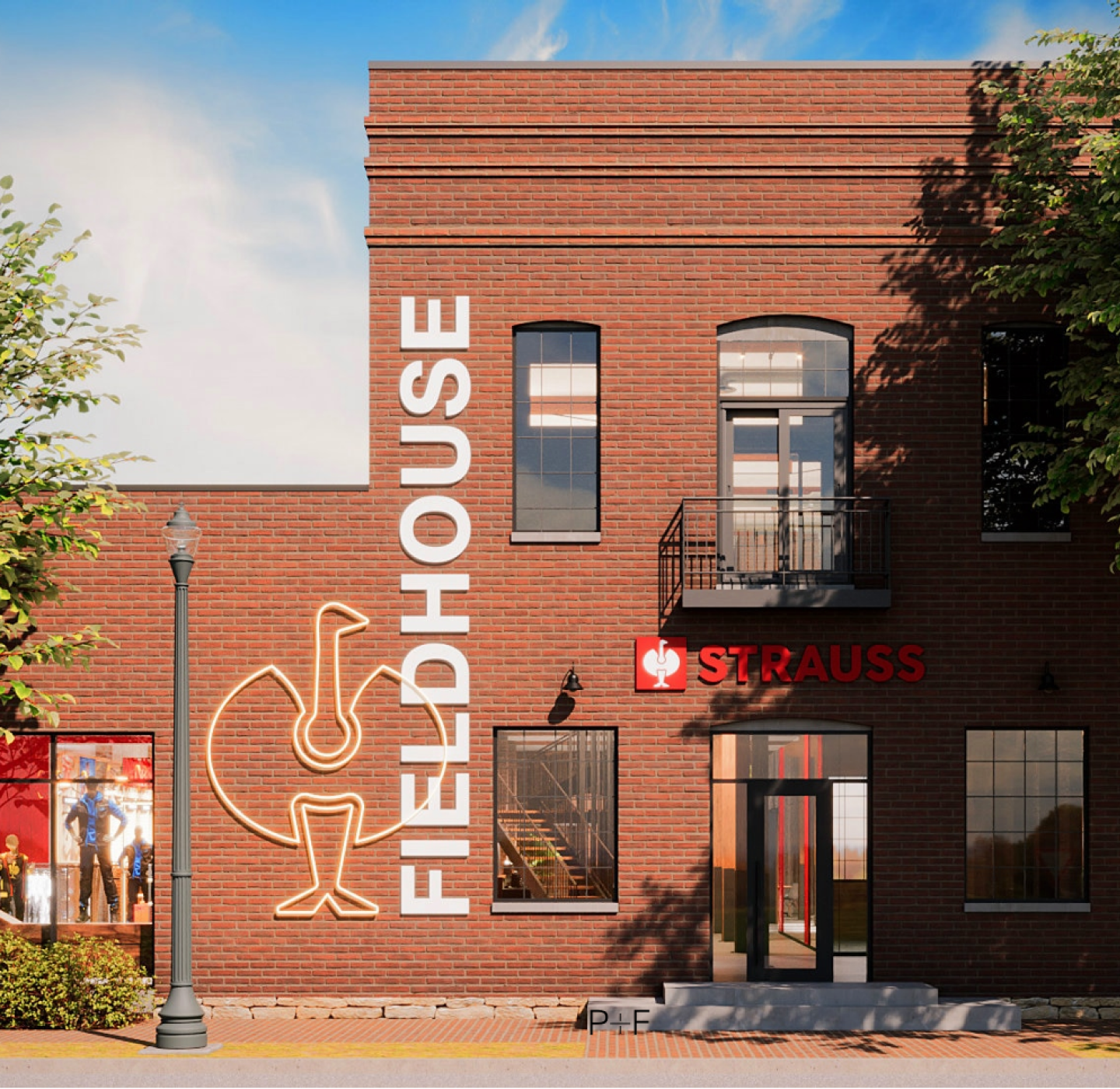 A brick building with FIELDHOUSE in large letters, a sports-themed mural, and a sign reading STRAUSS above a red door. Trees and a lamppost stand nearby.