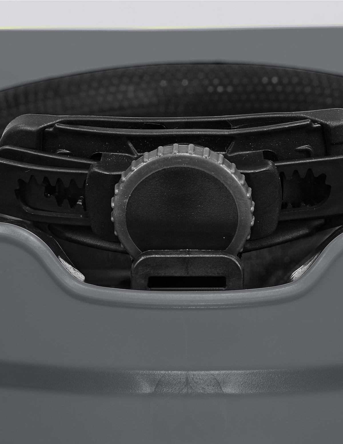 Close-up of the black adjustable dial on the STRAUSS Baseball Style Hard Hat in gray, featuring a textured grip and gear-like edges that allow you to easily tighten or loosen the fit for optimal multi-directional impact protection.