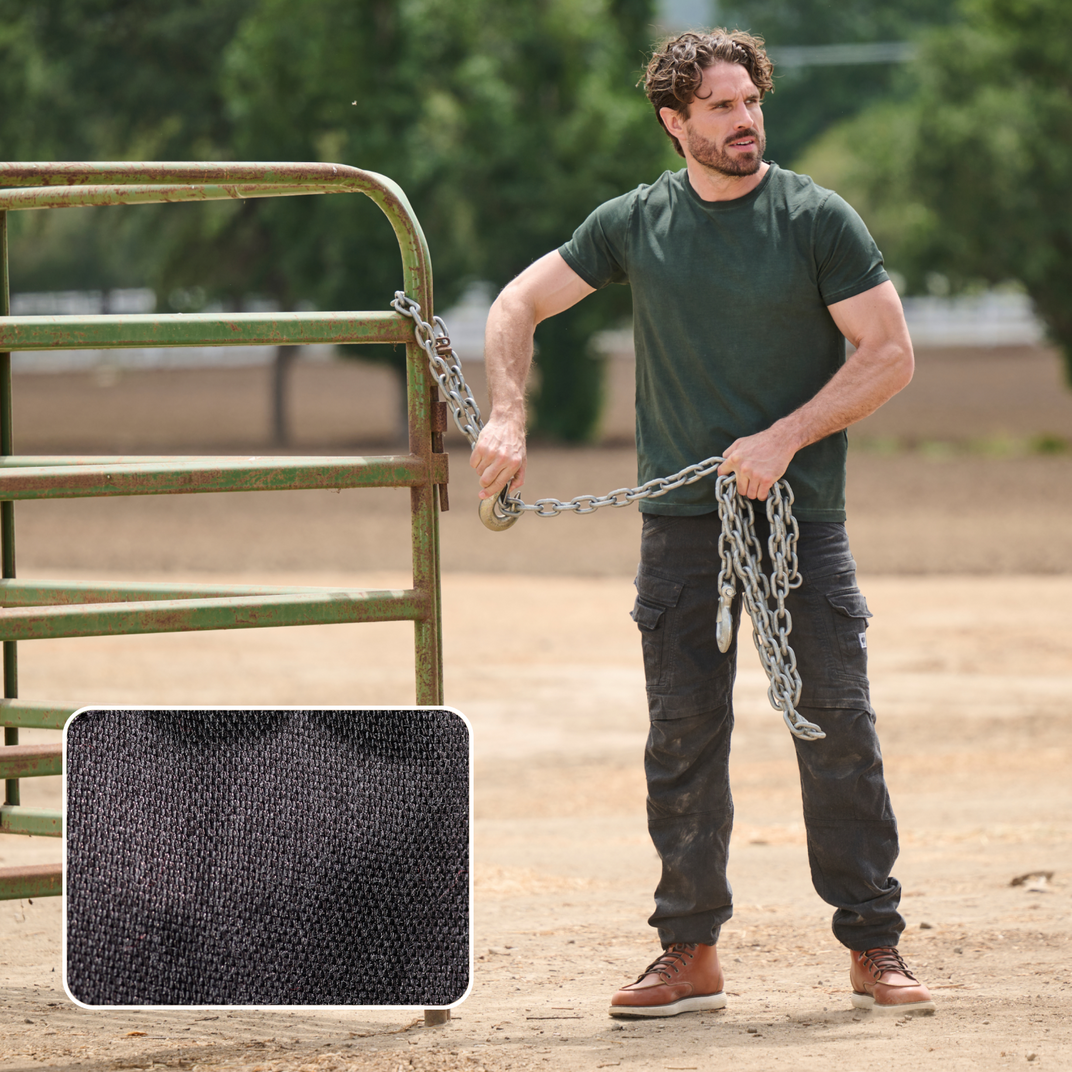 Man unlocking a metal gate with a chain, with a special focus on the canvas fabric.