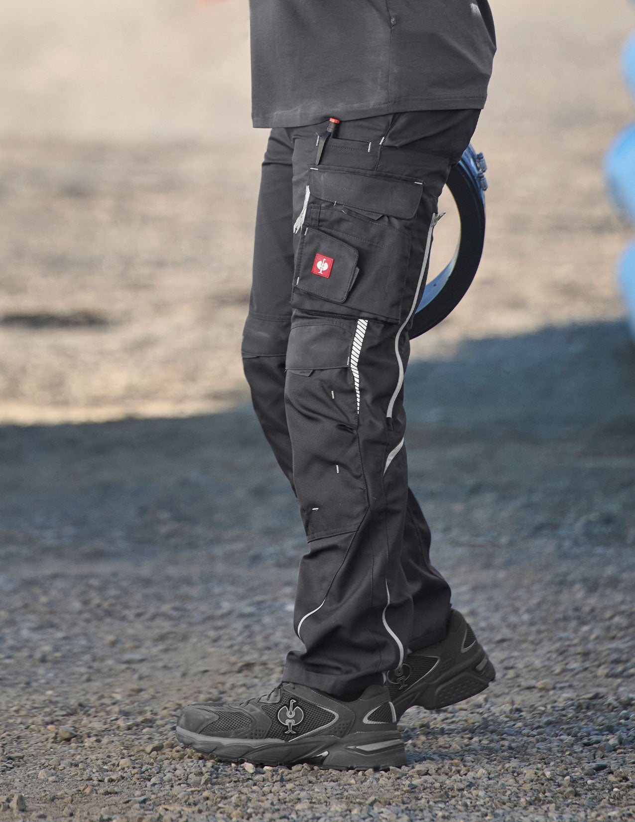 Man wearing grey pants with multiple pockets on the side