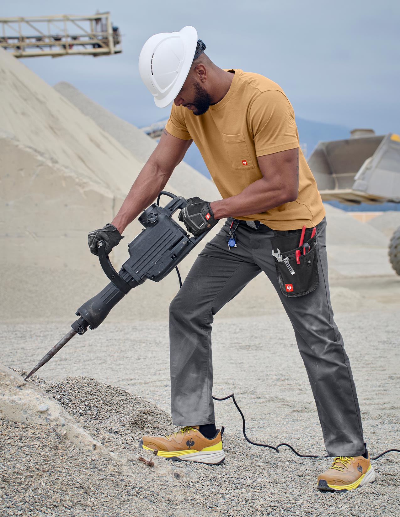 Person using a demolition hammer on a construction site