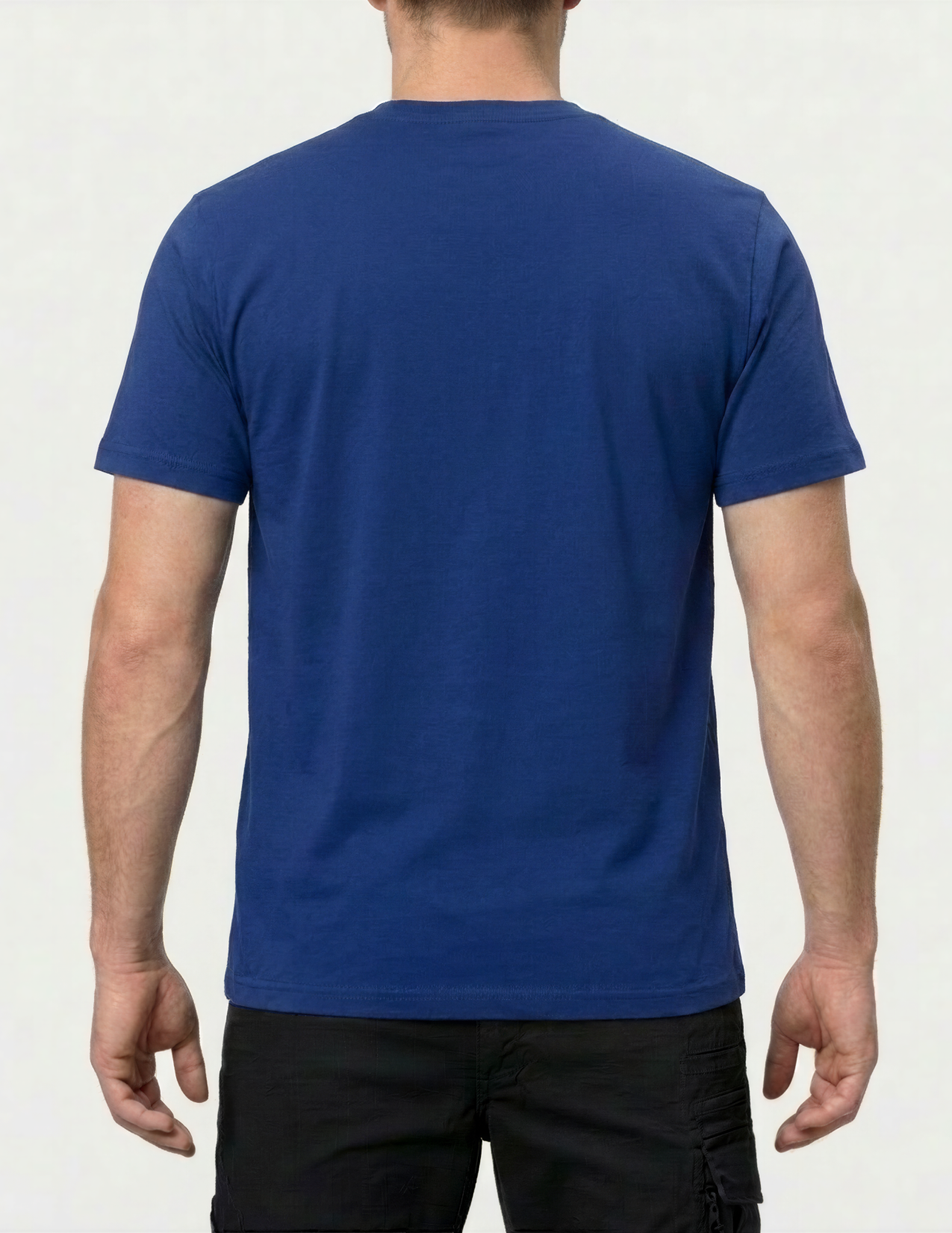 Person wearing a blue t-shirt on a plain background