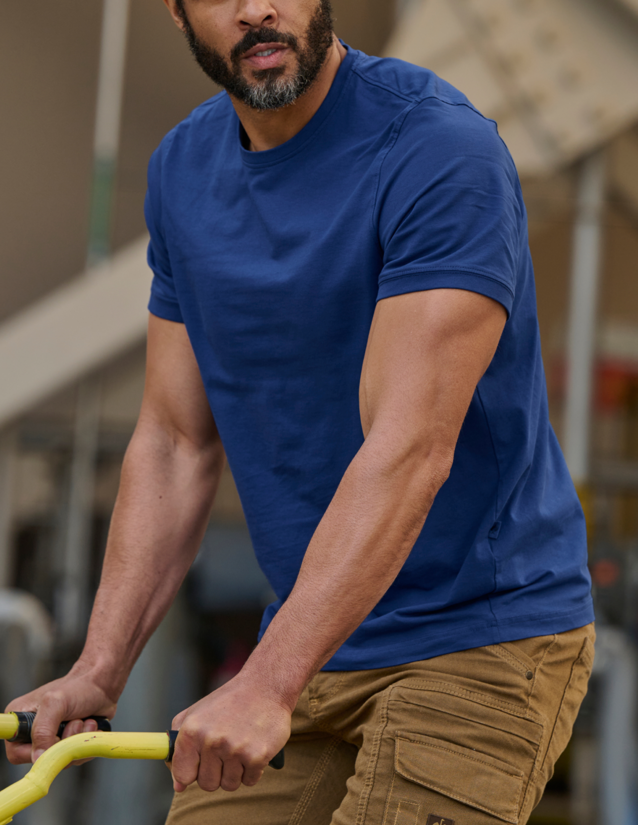Man wearing a blue t-shirt and brown pants
