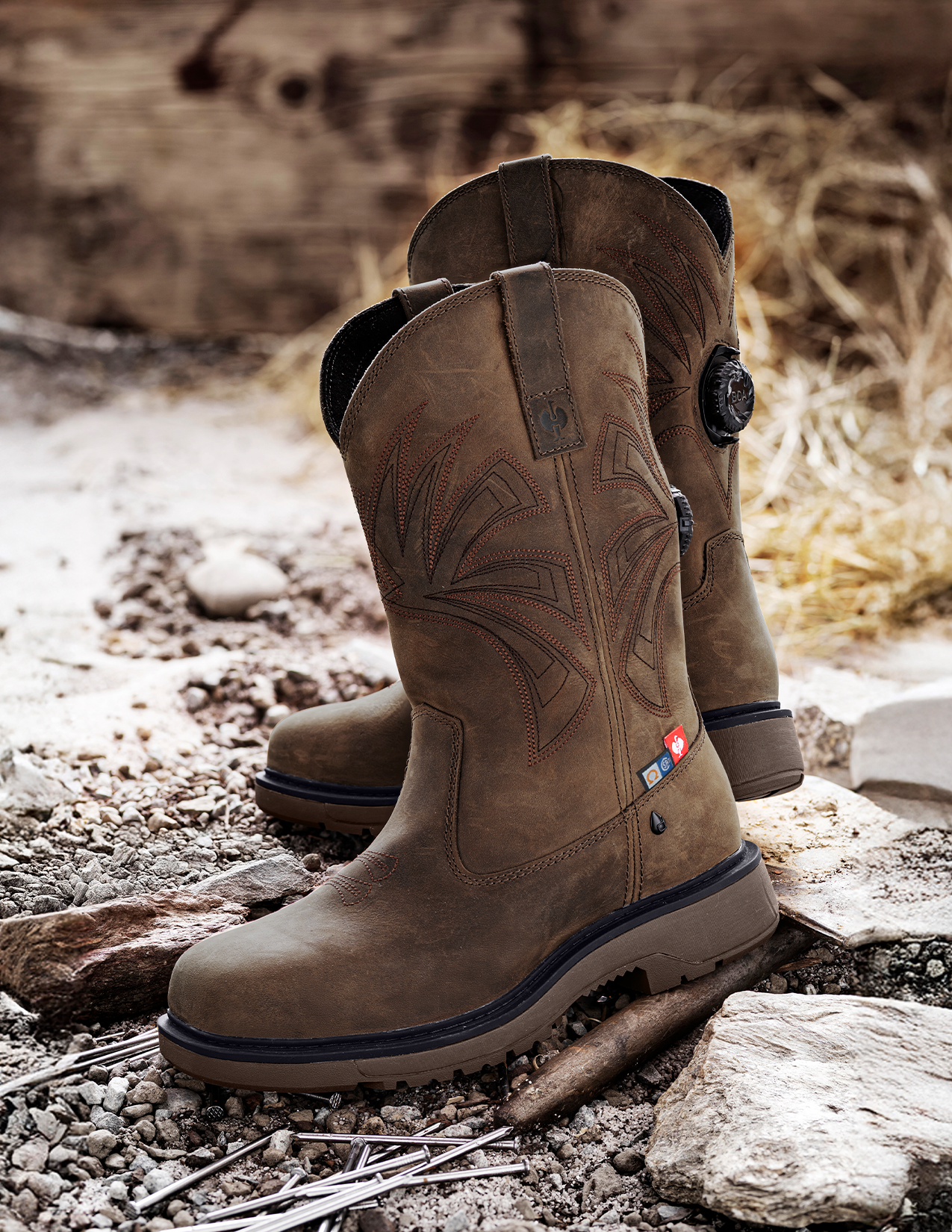 Brown work boots on a rocky ground with a natural background