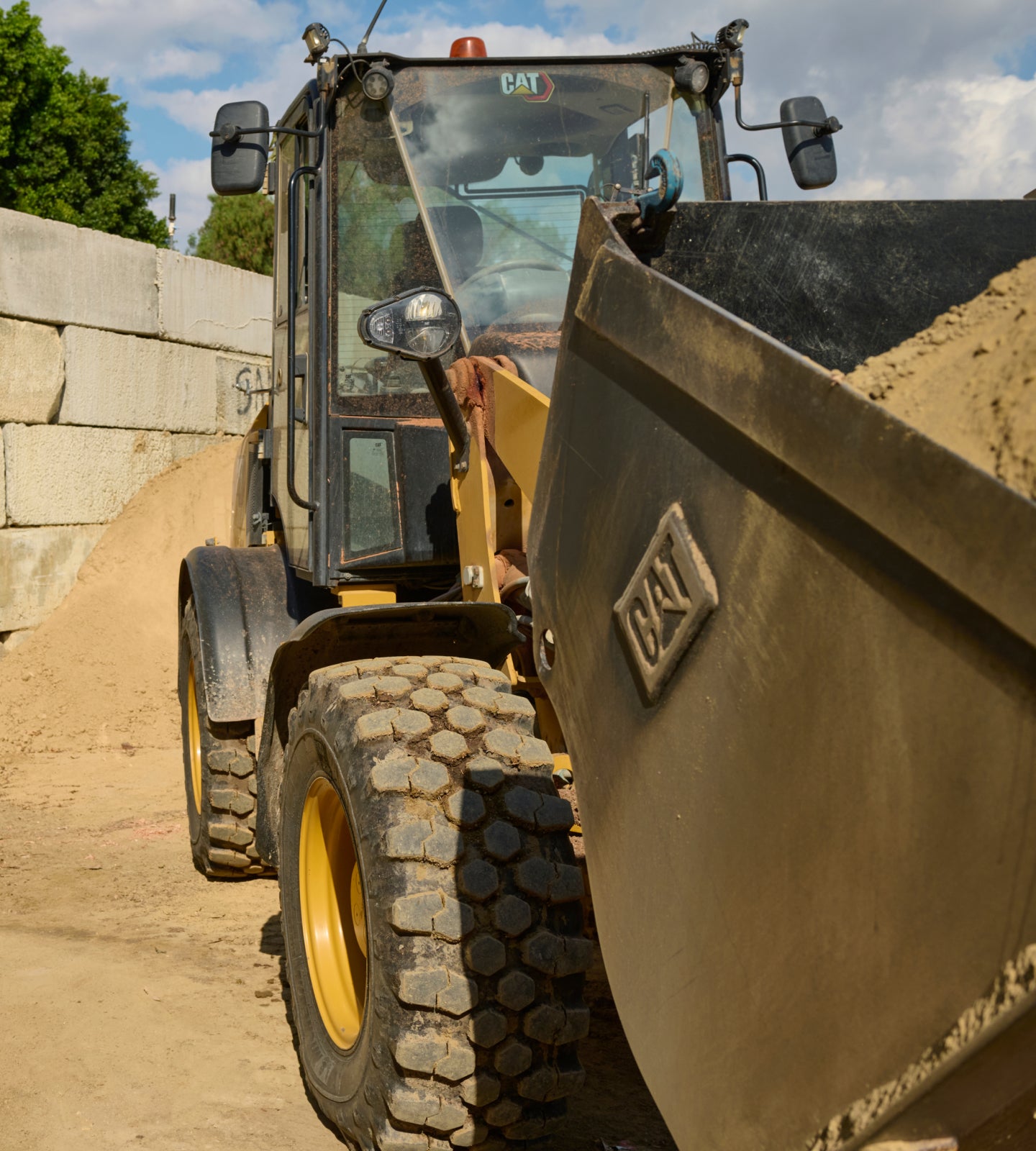 A scenery of a concrete jobsite with an excavator.