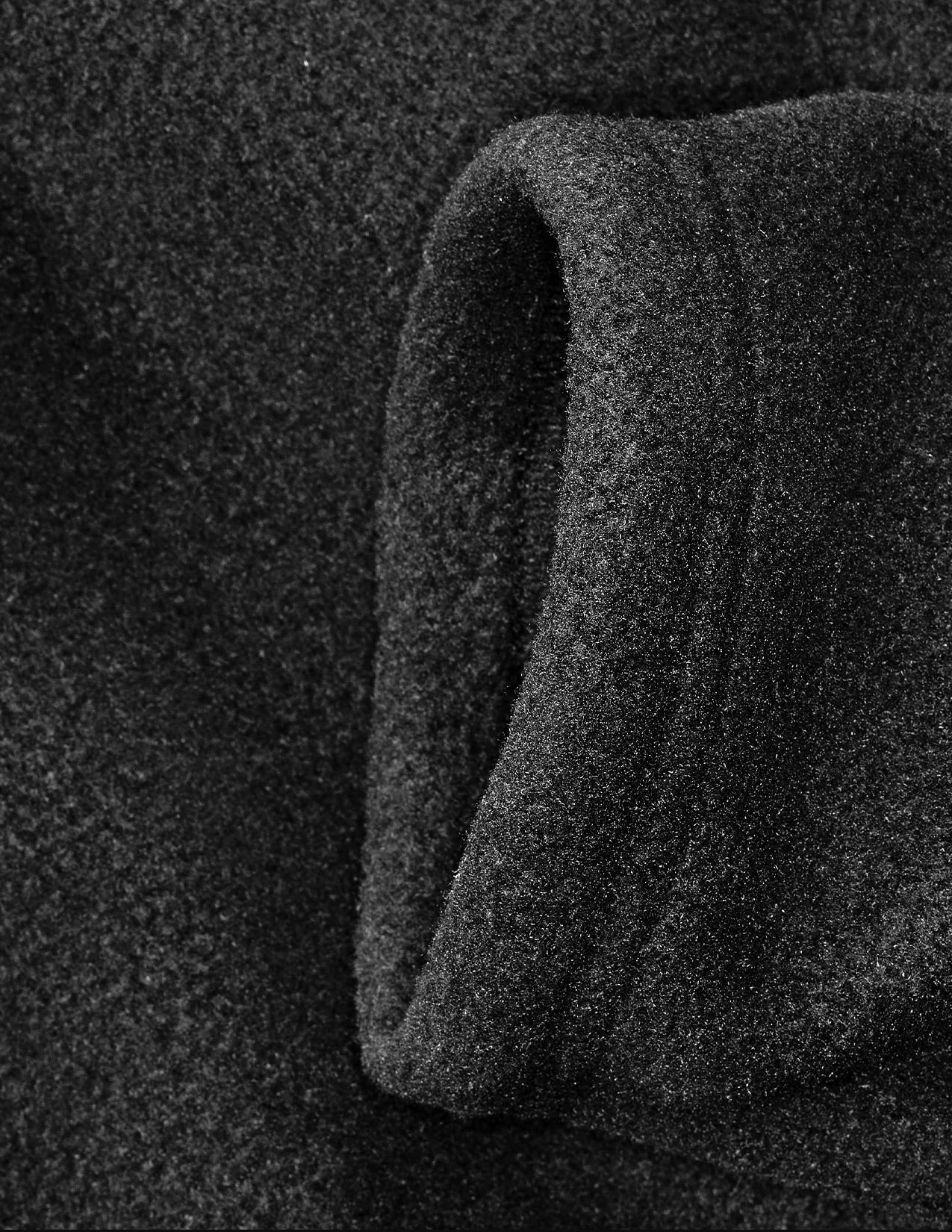 Close-up of textured black fabric with a dark background
