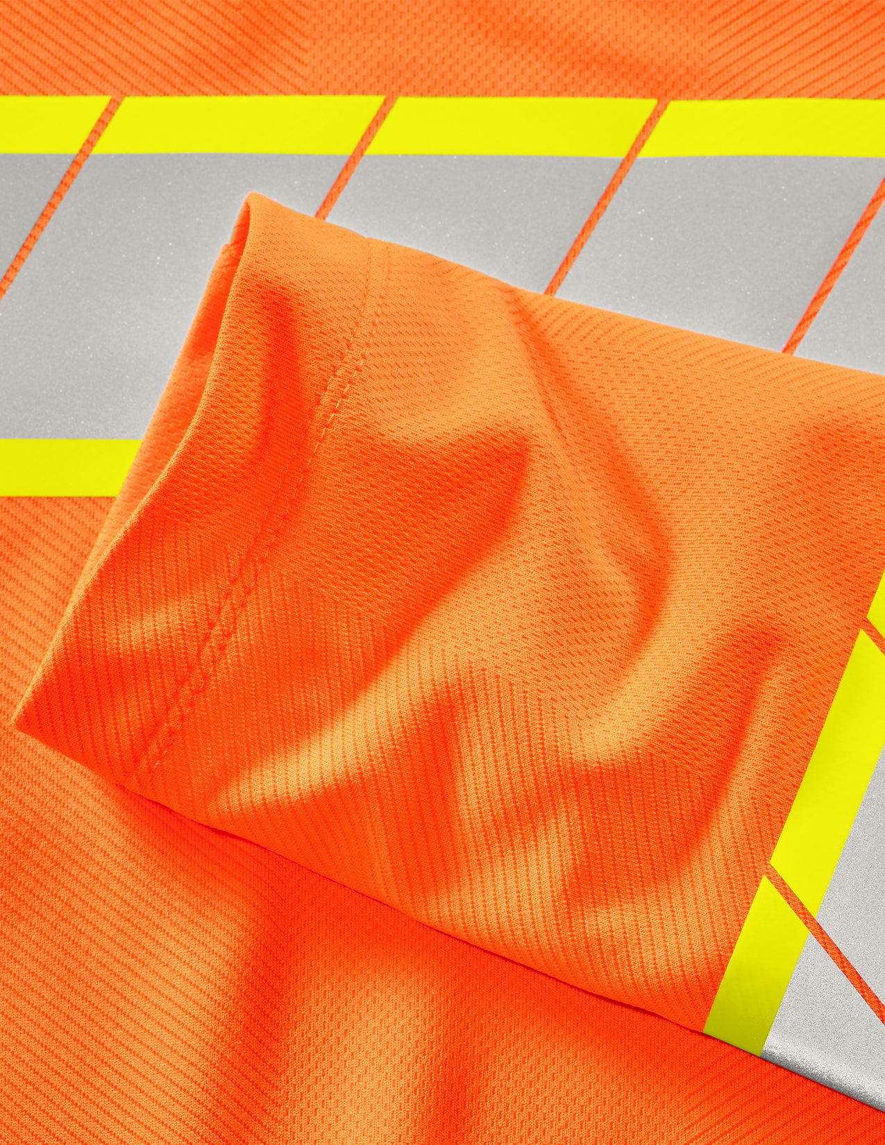 Close-up of orange fabric with gray and yellow stripes