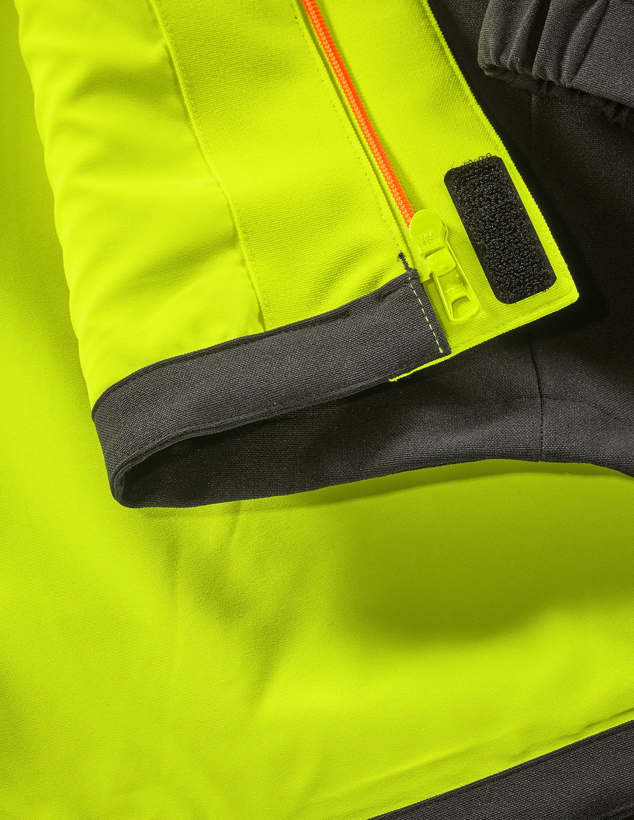 Close-up of a bright neon yellow jacket with black and orange accents