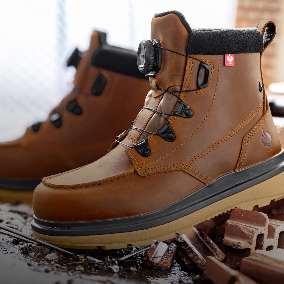 Brown work boot with a light on top, surrounded by construction materials.
