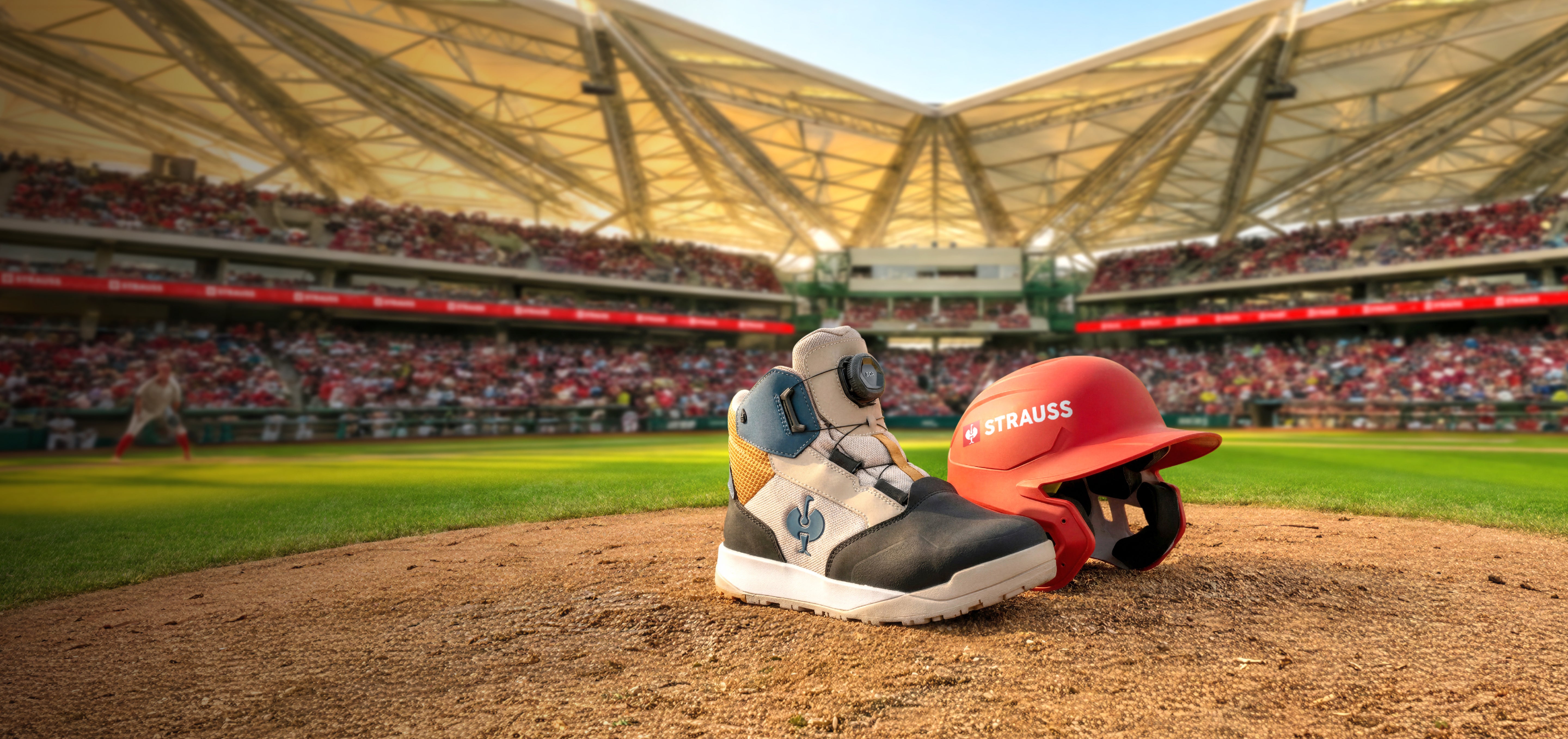 Baseball helmet and work boots on a baseball field with stadium in the background