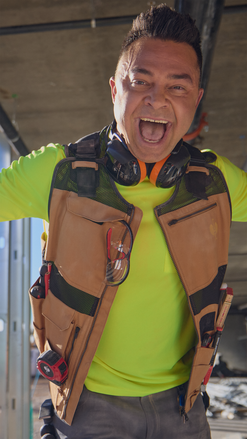 Nick Swisher wears a STRAUSS tool vest and looks excited to camera. 