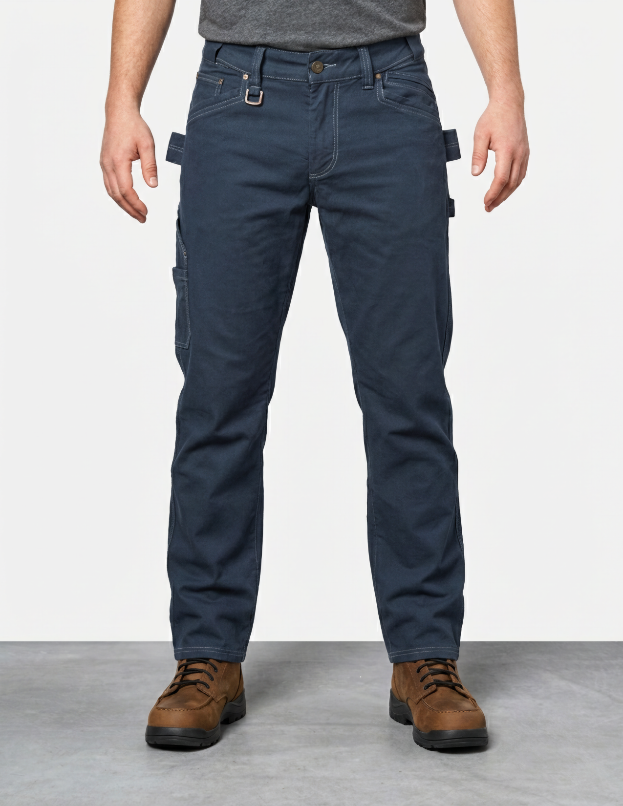 Person wearing navy blue pants with multiple pockets on a light gray background
