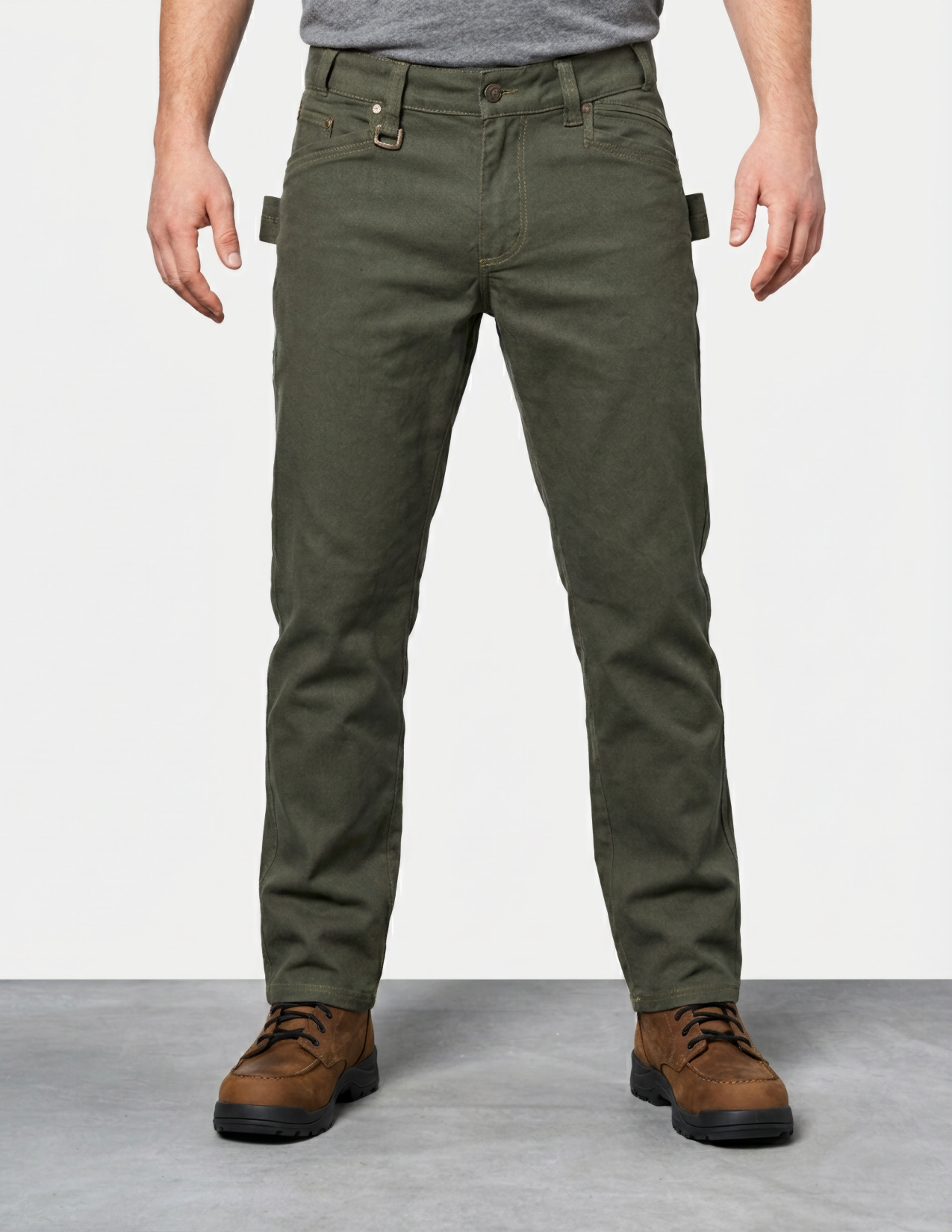 Person wearing green pants and brown shoes on a plain background