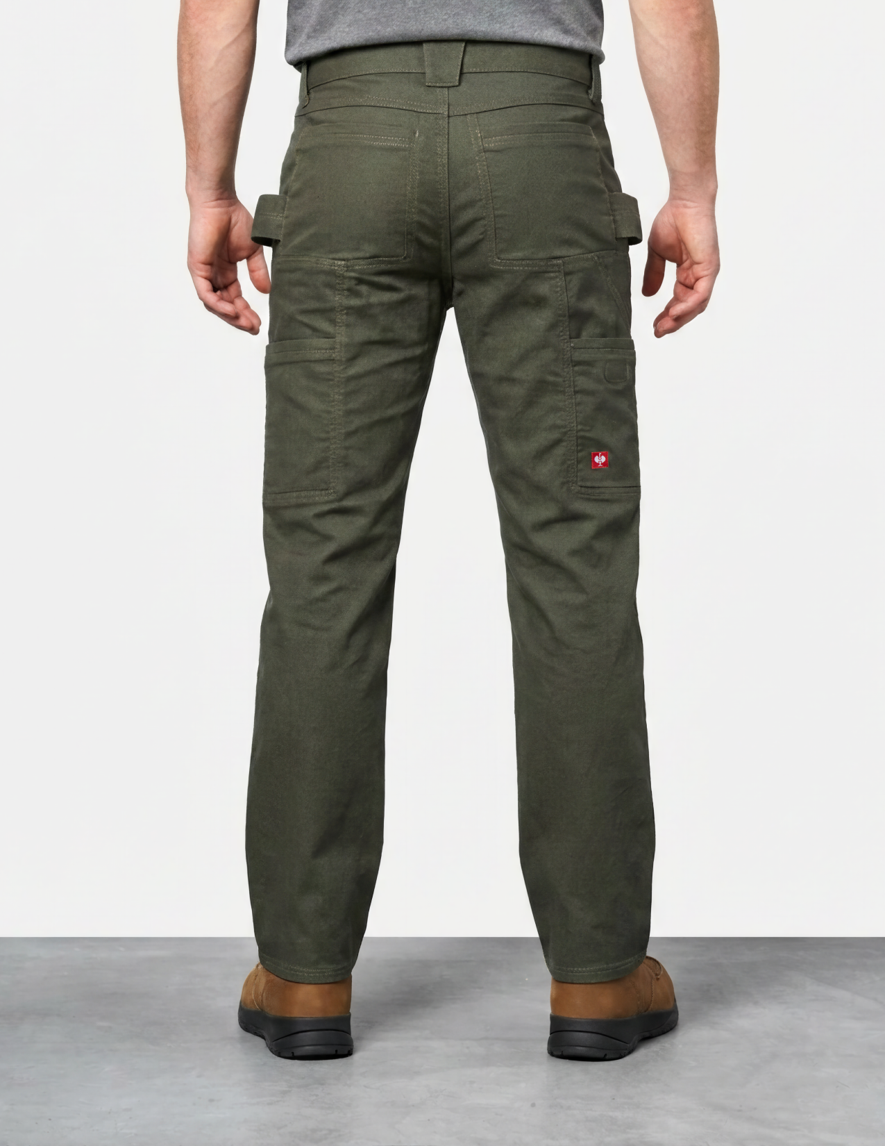 Person wearing green cargo pants on a plain background