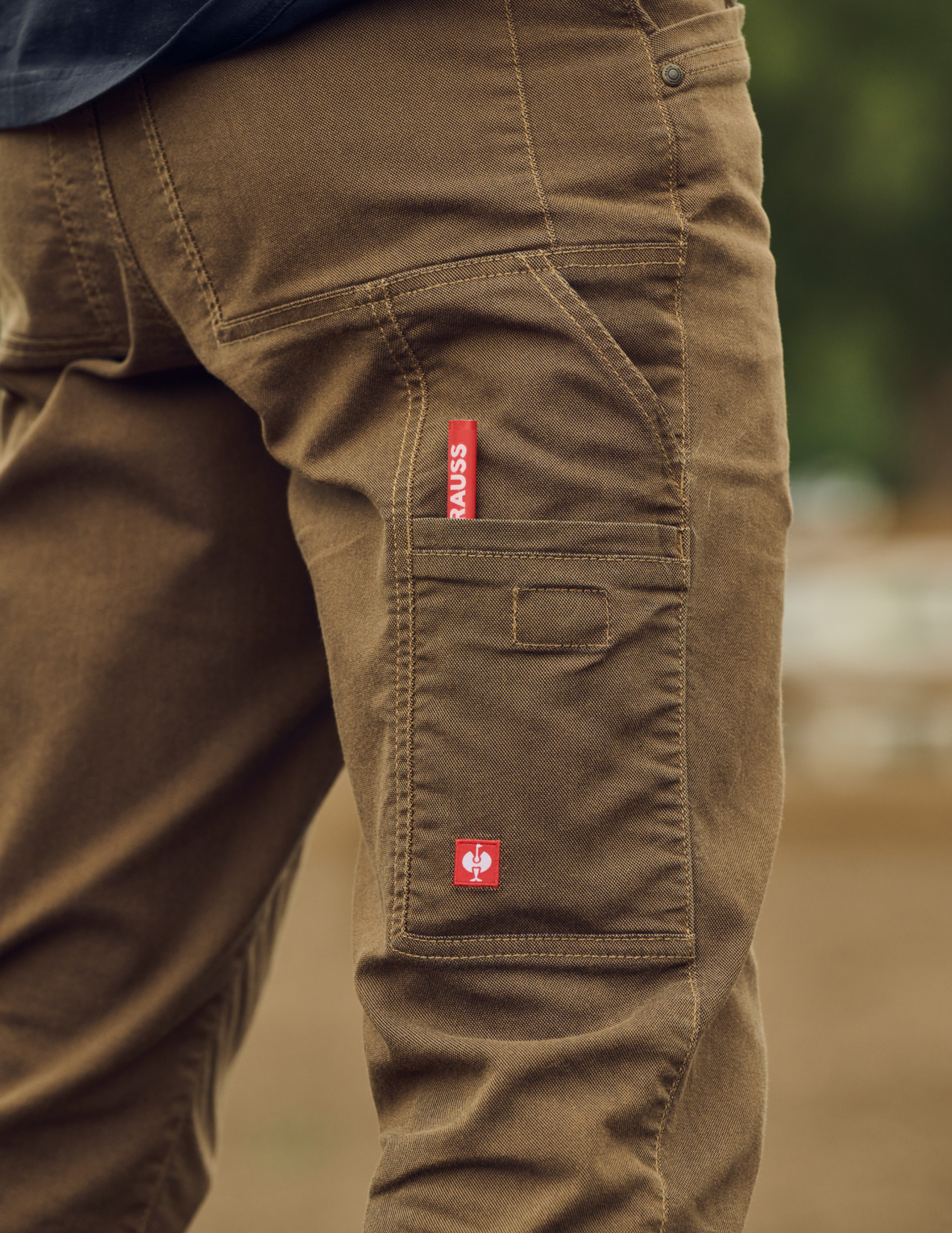 Brown pants with a red label on a blurred background