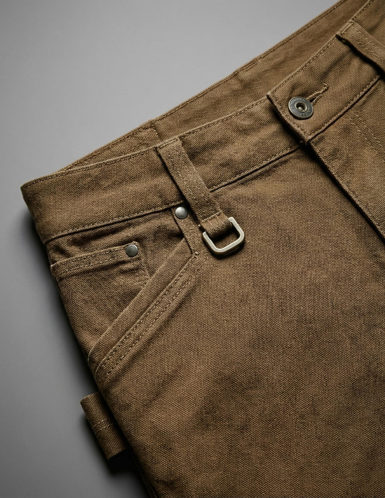Brown pants with a buckle on a gray background