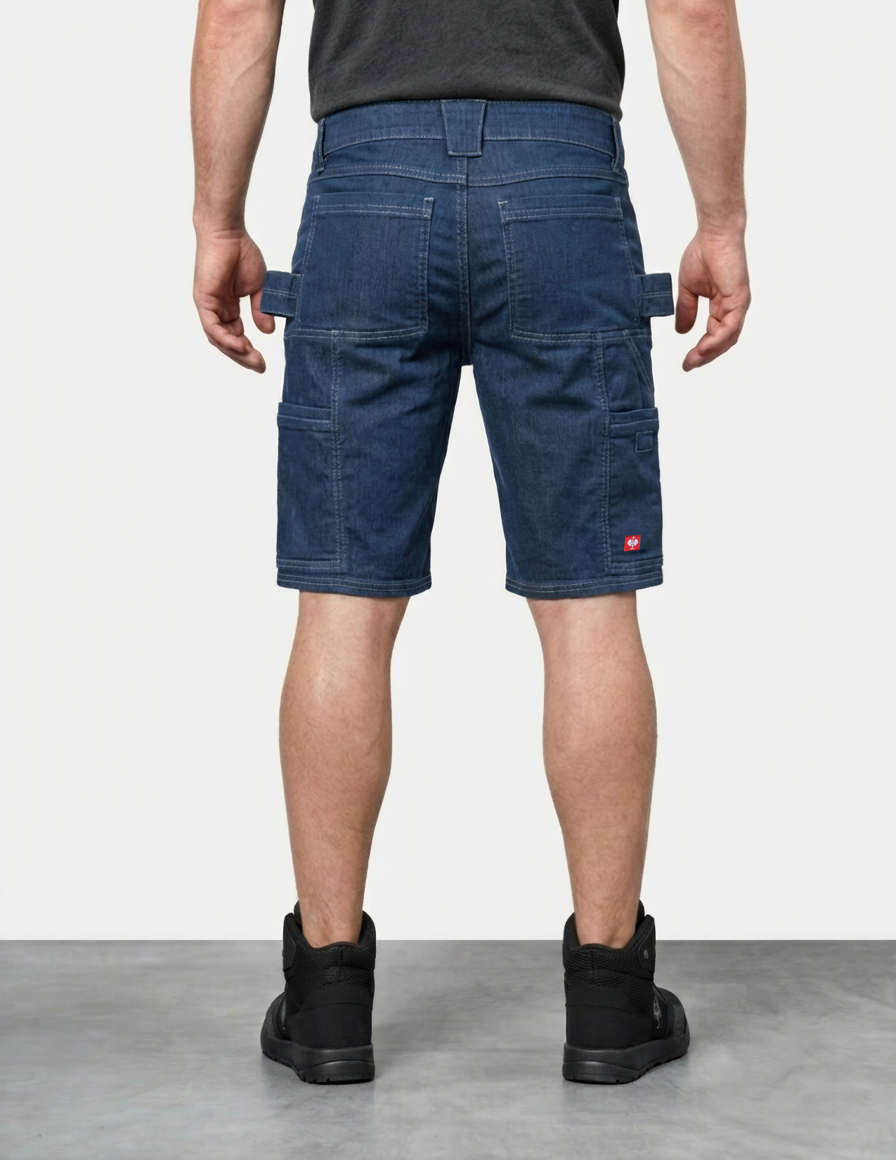 Person wearing blue cargo shorts on a plain background