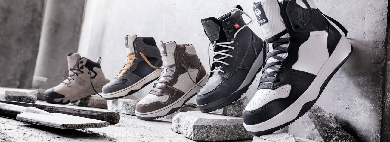 Five pairs of high-top sneakers in various neutral colors are displayed on concrete slabs against a gray industrial background.