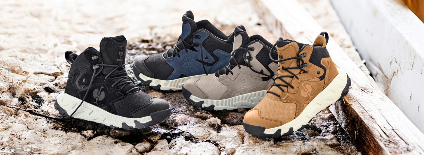 Four pairs of winter boots in black, blue, gray, and brown on a snowy ground.