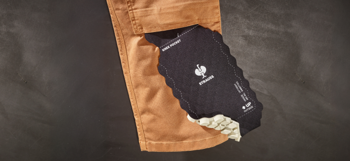 Close-up of a brown pants pocket with a black phone case and money on a dark background