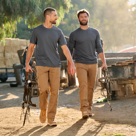 Two men walking on a horse ranch