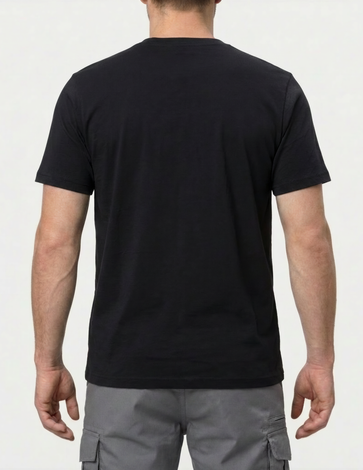 Person wearing a black t-shirt and gray cargo pants on a white background