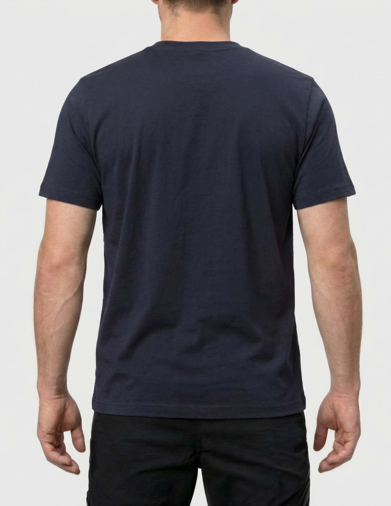 Person wearing a navy blue t-shirt on a plain background