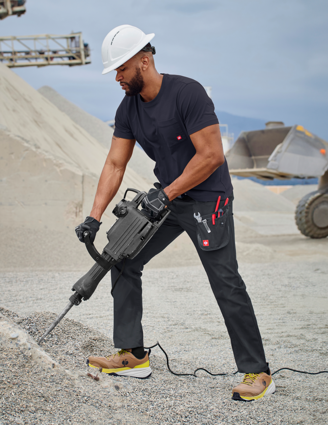 Person using a jackhammer in an industrial setting