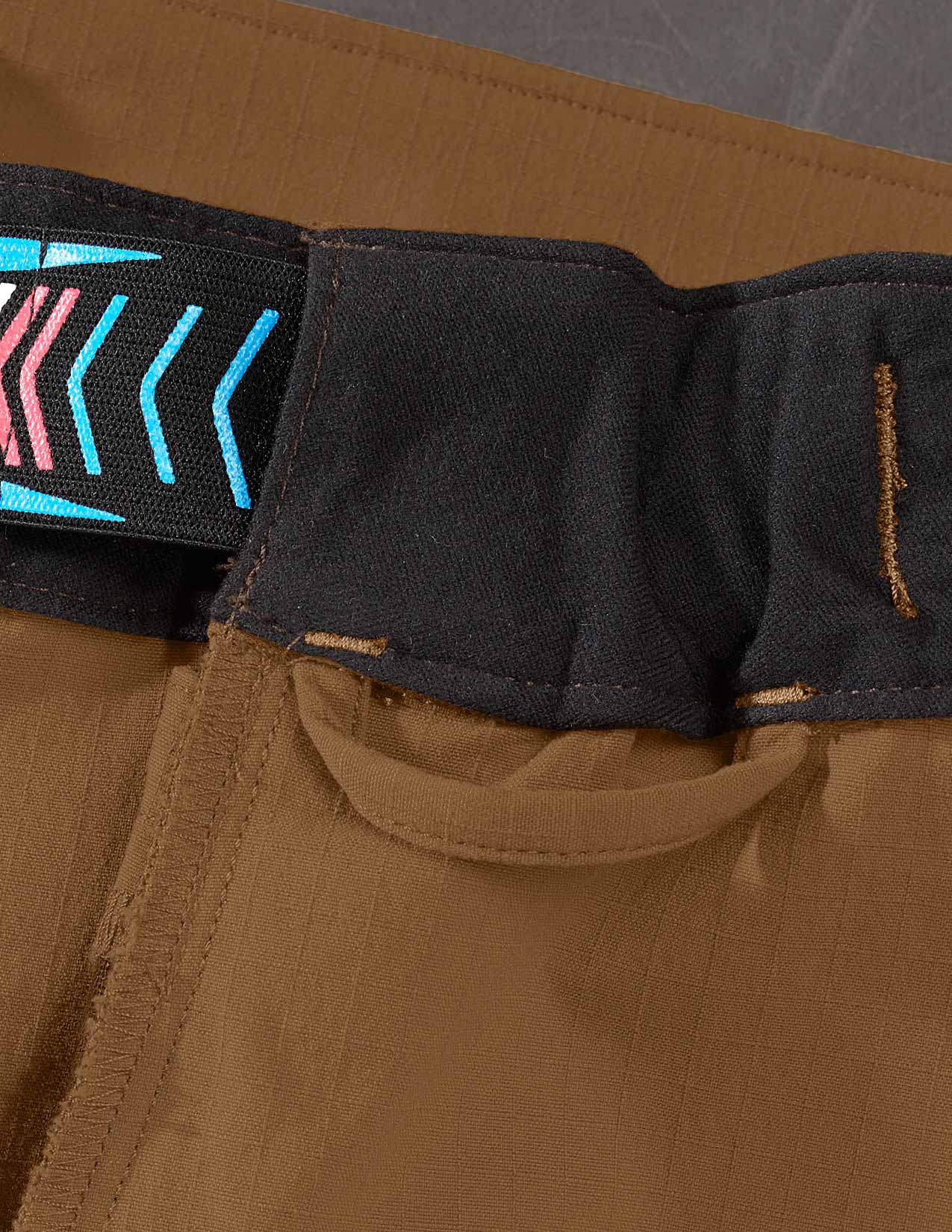 Close-up of brown pants with loop for suspenders