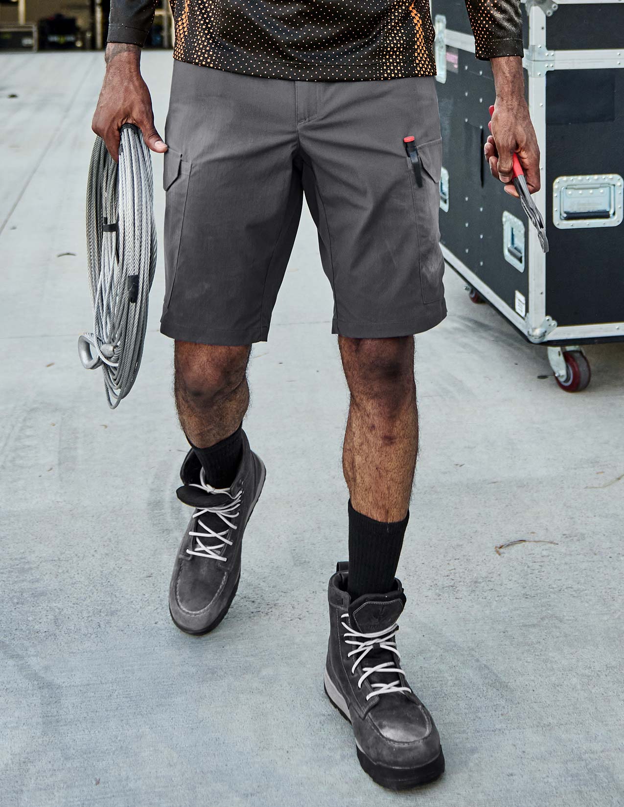 Person wearing gray shorts and black boots.