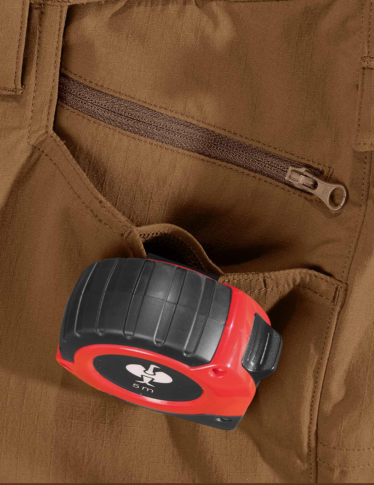 Red and black tape measure in a pocket
