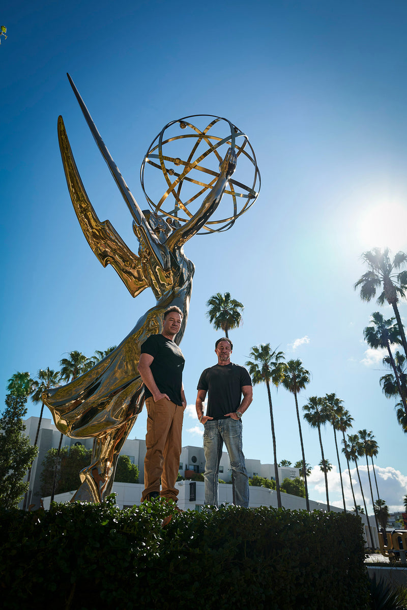 two people in front of a statue