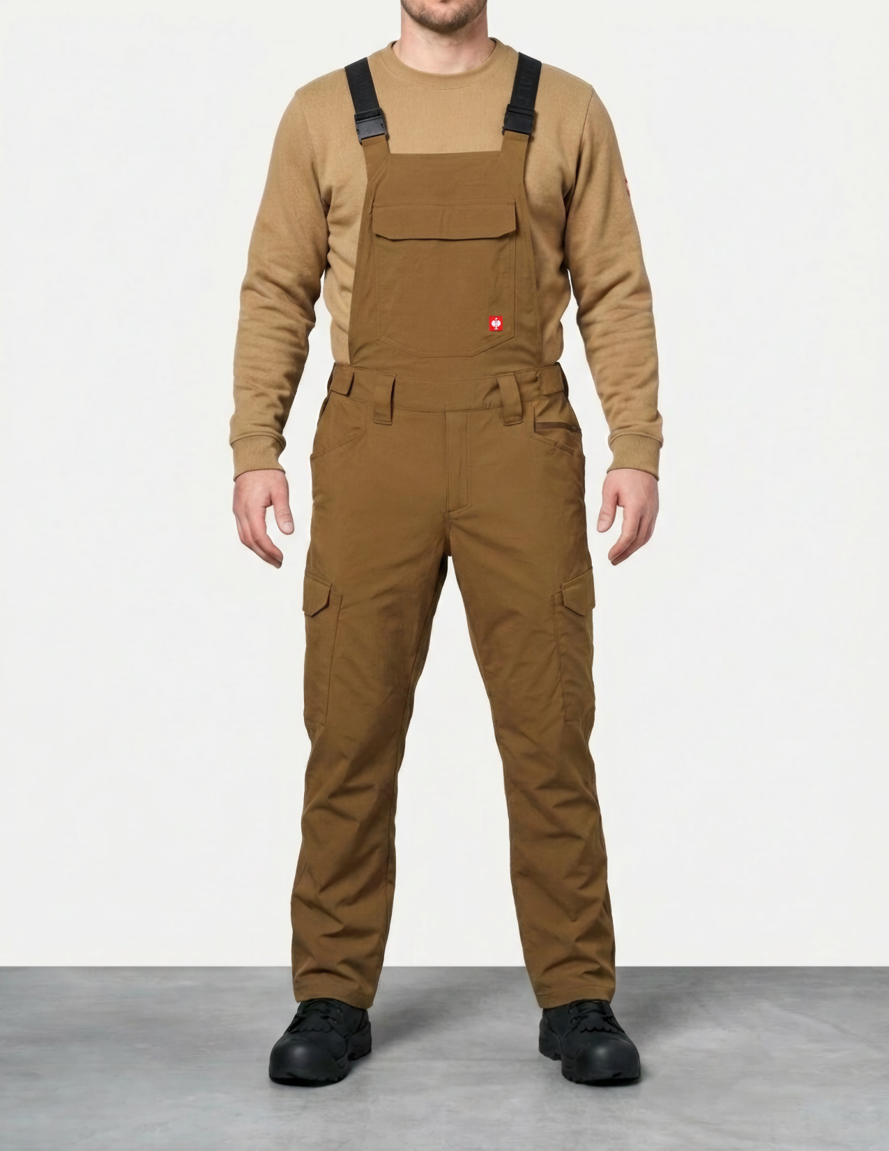 Person wearing brown bib overalls and a matching long-sleeve shirt on a white background