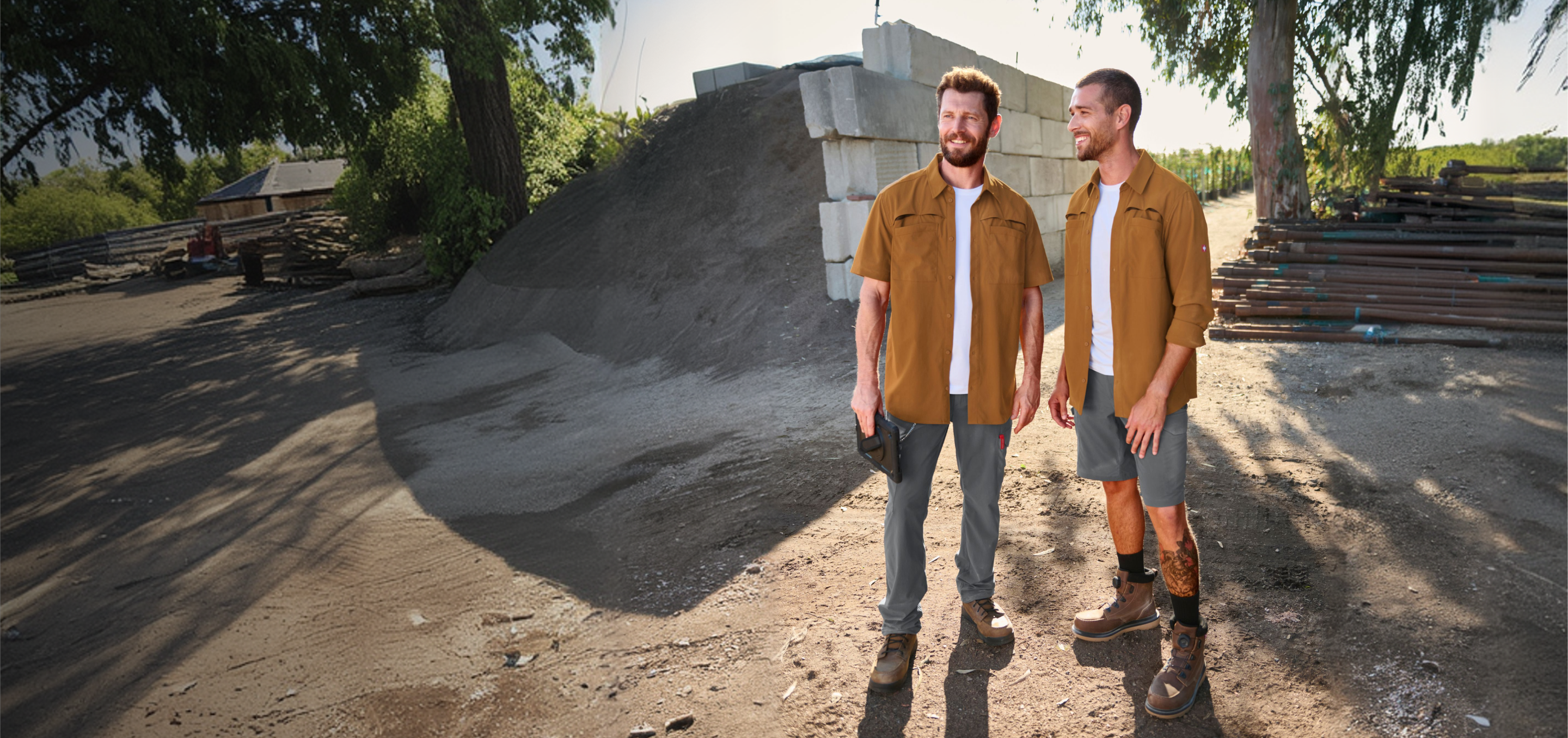 Two men standing on a construction site wearing workwear
