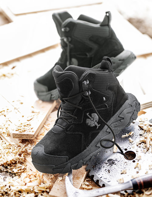 a pair of black boots on a wood surface