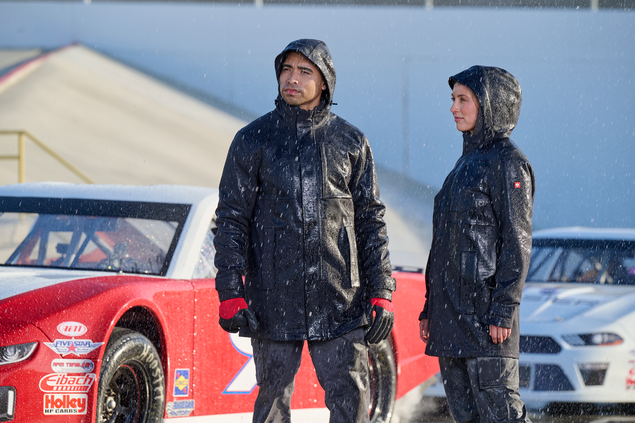 A man and a women stand in the rain in thigh length waterproof jackets
