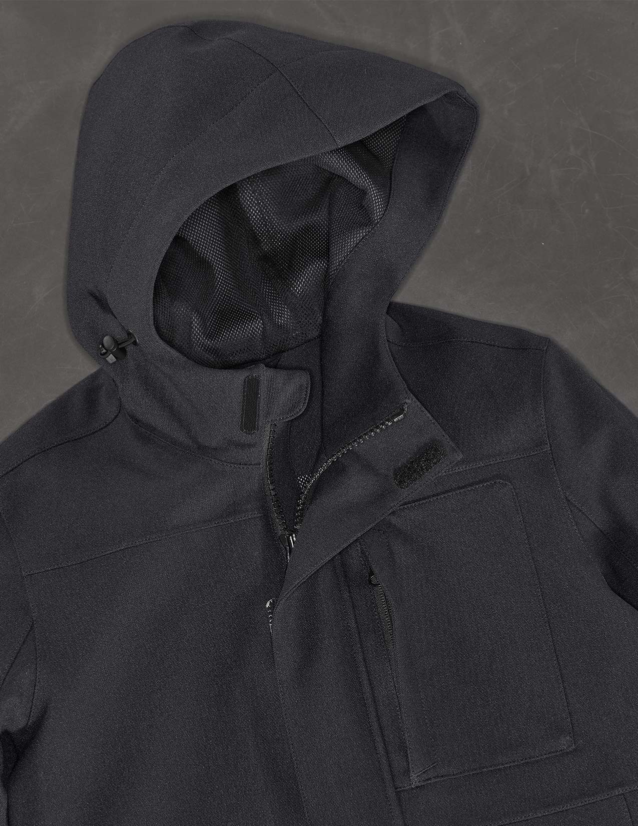 Dark black hooded jacket on a textured gray background