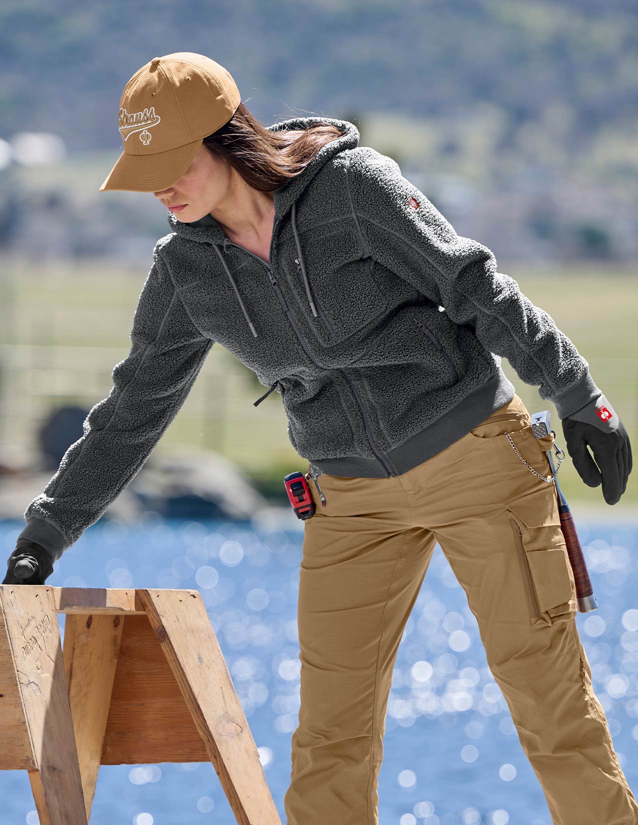 Women wearing a gray jacket and tan pants on a construction site