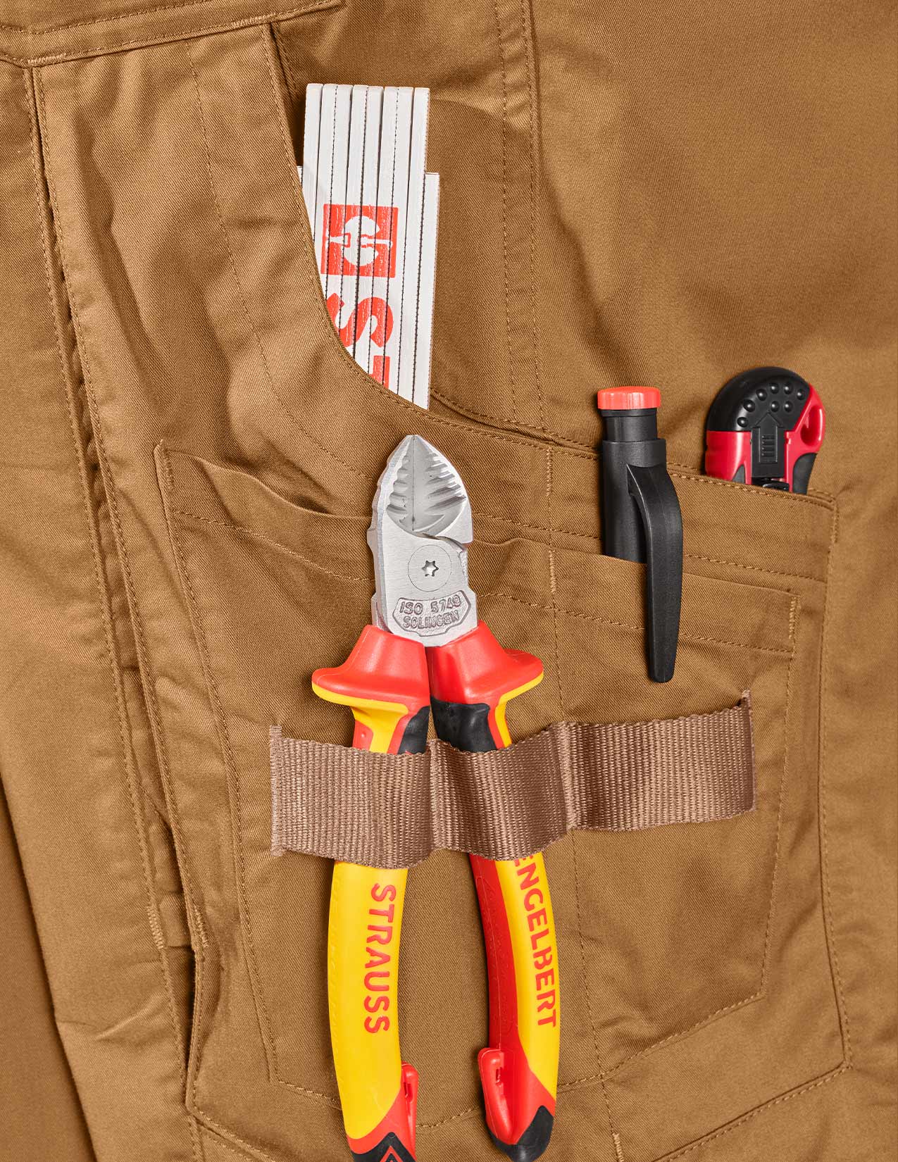 Brown work pants with various tools in the pockets, including pliers and a knife.