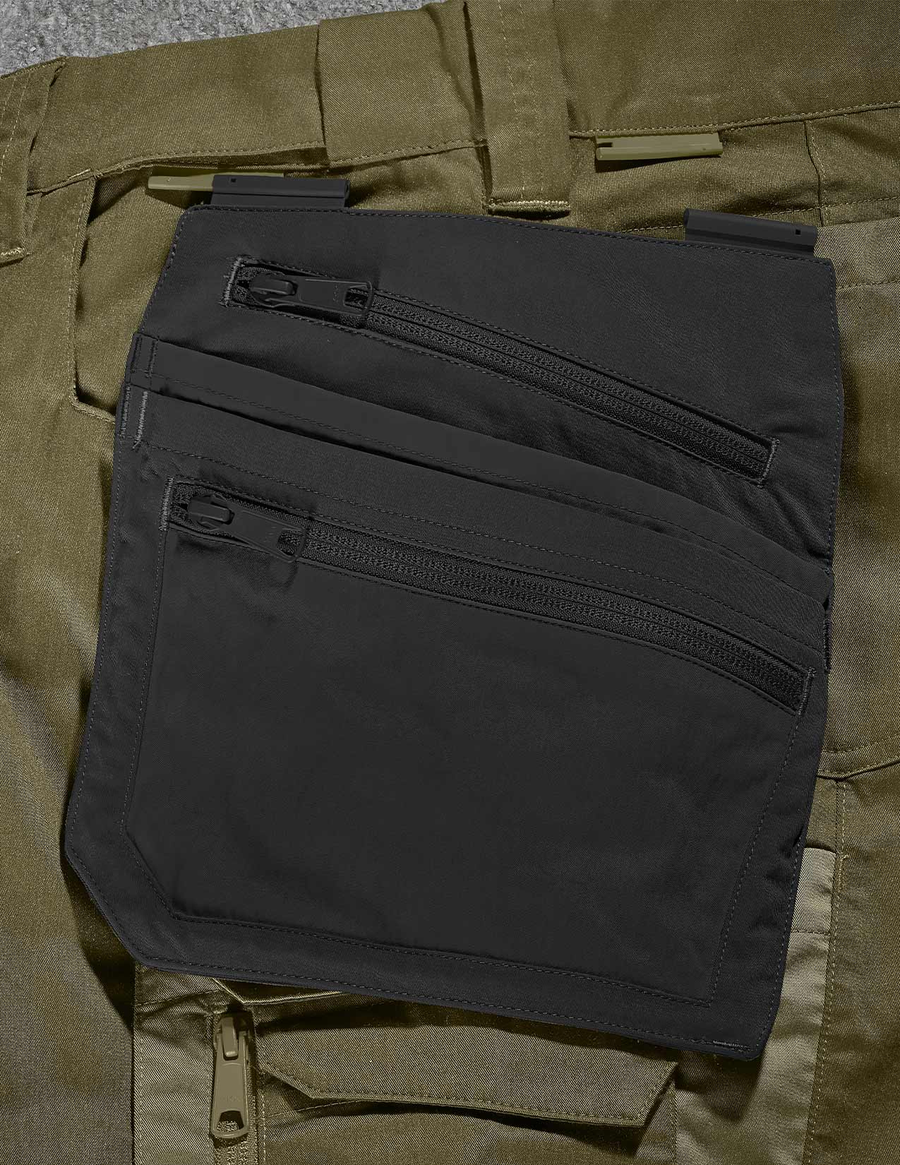 Close-up of a black pocket on a green pants