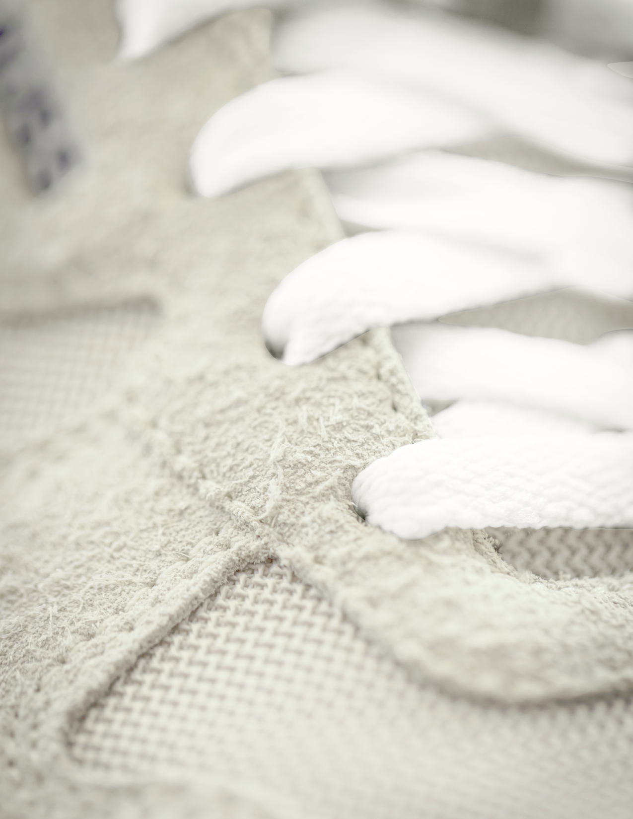 Close-up of textured fabric with a white lace trim