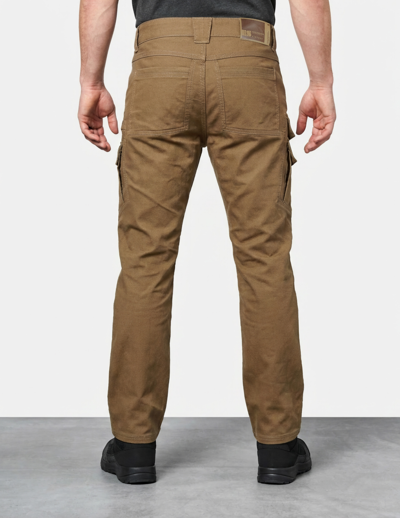 Sepia work pants worn by a person on a plain background