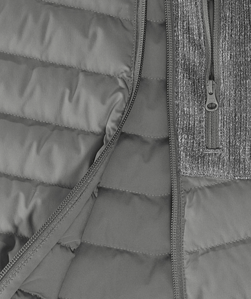 Close-up of STRAUSS e.s.motion ten Hybrid Hooded Jacket showing zipper, pocket, and weather-ready fabric.