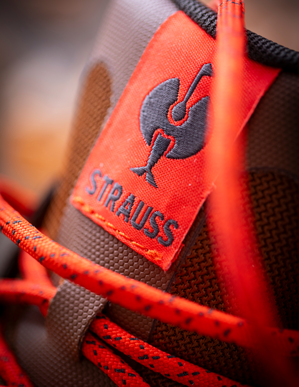 Close-up of a shoe with a red label featuring the brand logo