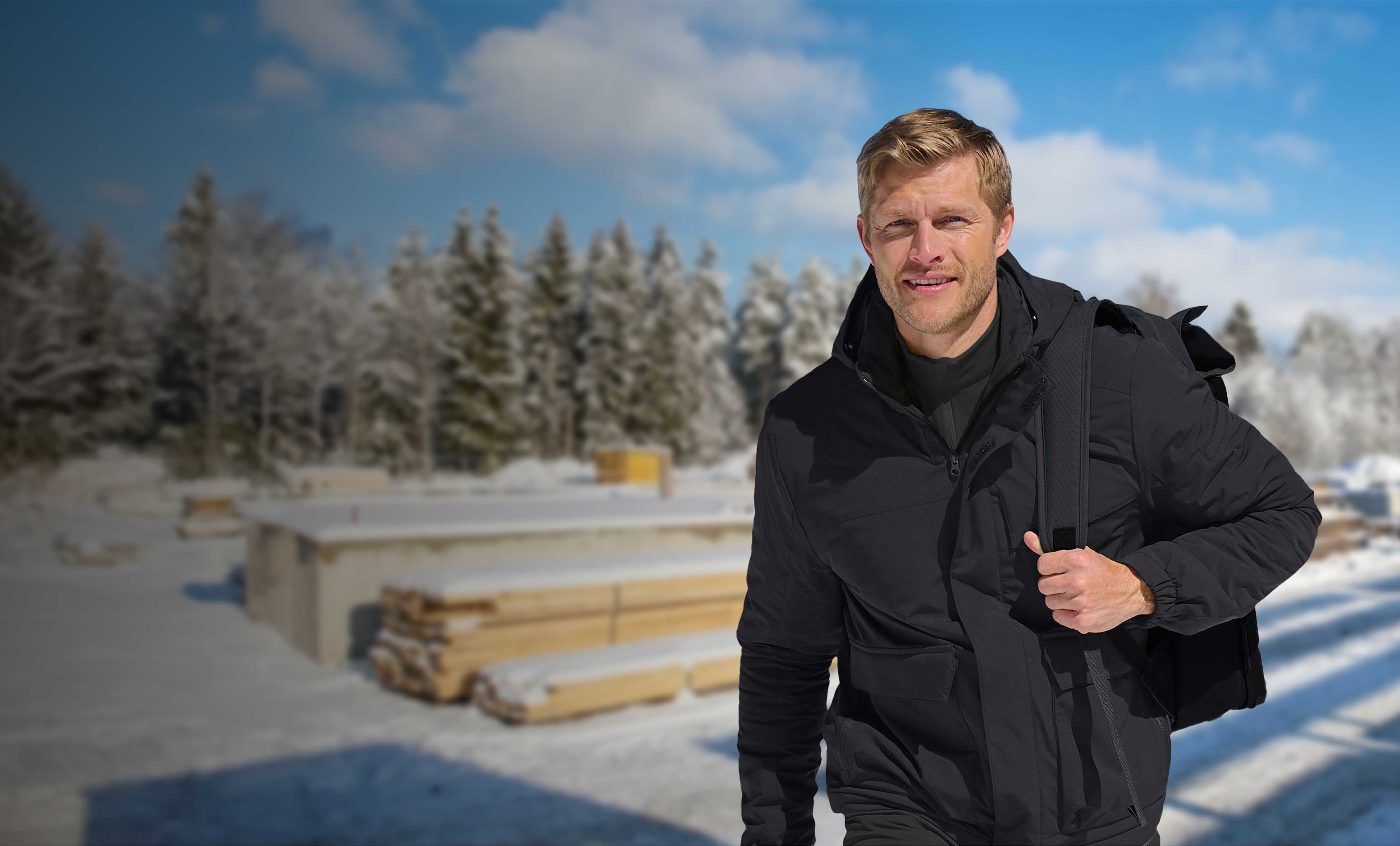 a man walking on a snowy construction site