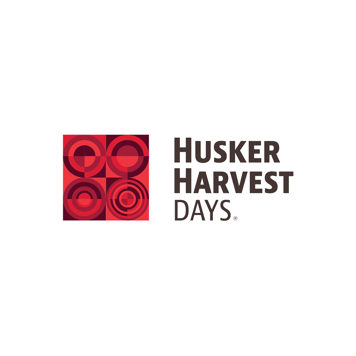 Husker Harvest Days logo with red geometric design on a white background