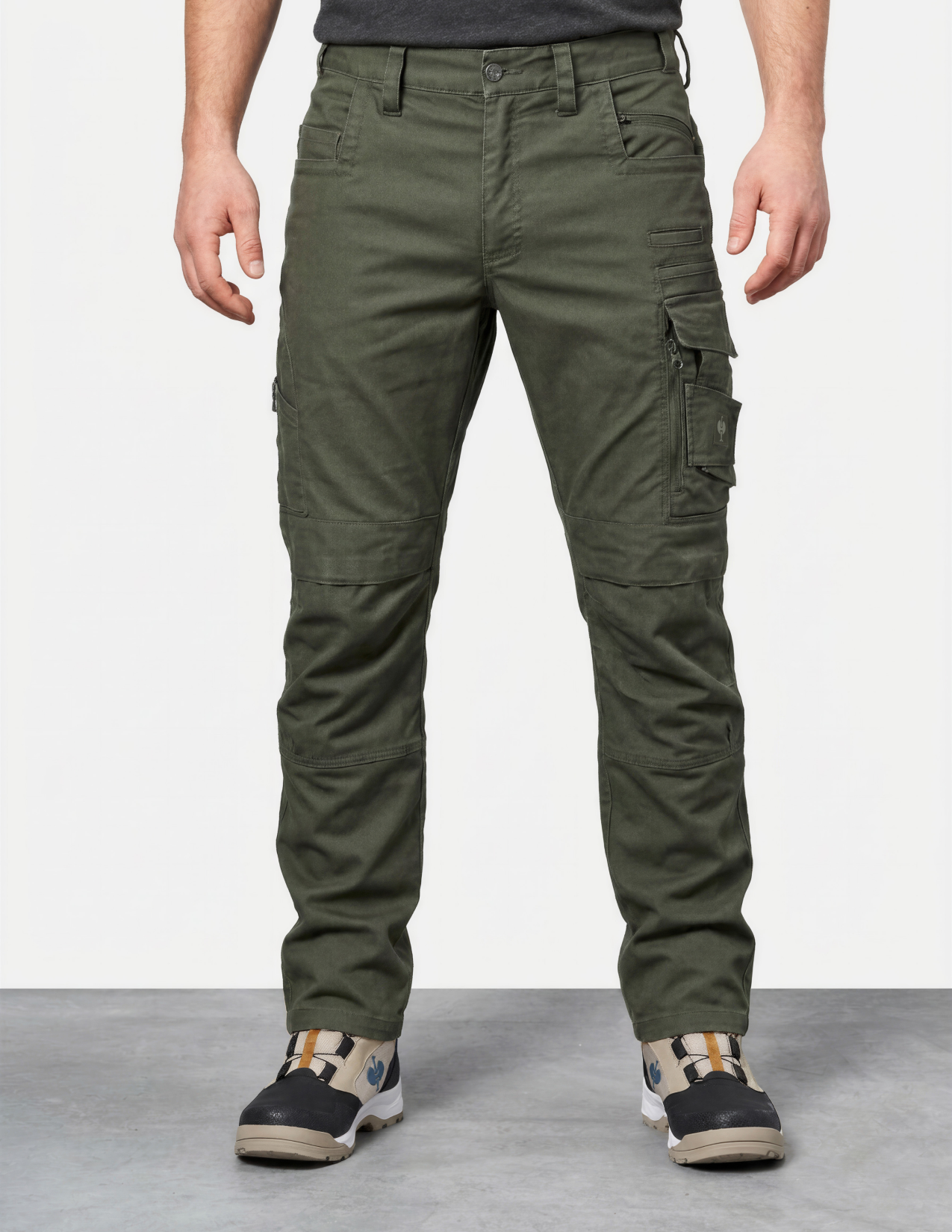 Person wearing green cargo pants on a plain background